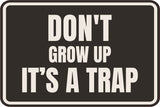 Classic Framed Plus Don't Grow Up IT's A Trap Wall or Door Sign | Funny Funny Home & Office Signage