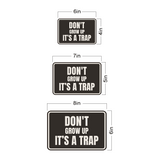 Classic Framed Plus Don't Grow Up IT's A Trap Wall or Door Sign | Funny Funny Home & Office Signage