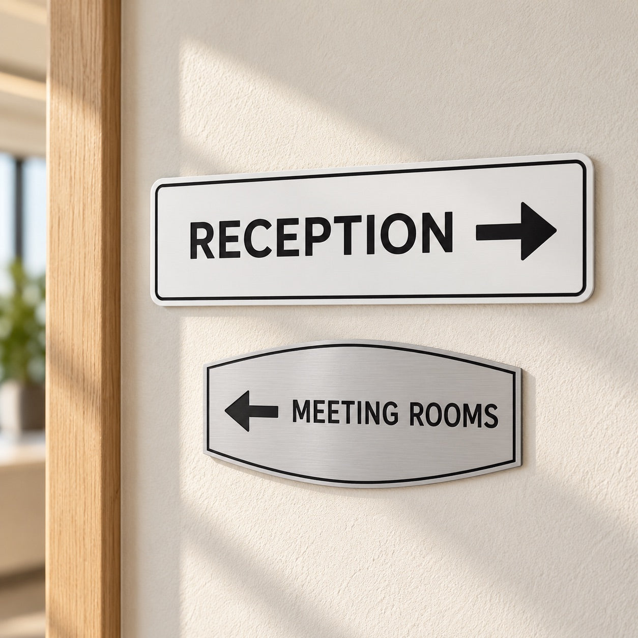 Directional signs for reception and meeting rooms on an office wall